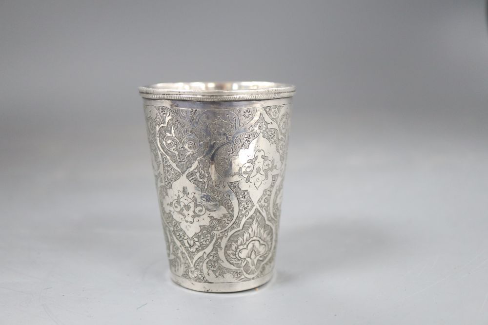 A Persian engraved white metal beaker, 71mm, 100 grams.